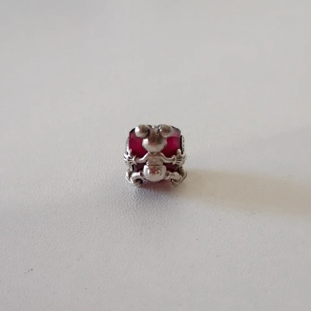 Pandora Disney Mickey Mouse Heart charm featuring a fuchsia crystal.